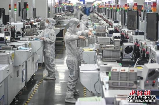 2月20日，位于广州南沙区的广东金晶科电子股份有限公司内，复工人员戴着口罩在生产车间有序工作。/p中新社记者 陈骥旻 摄
